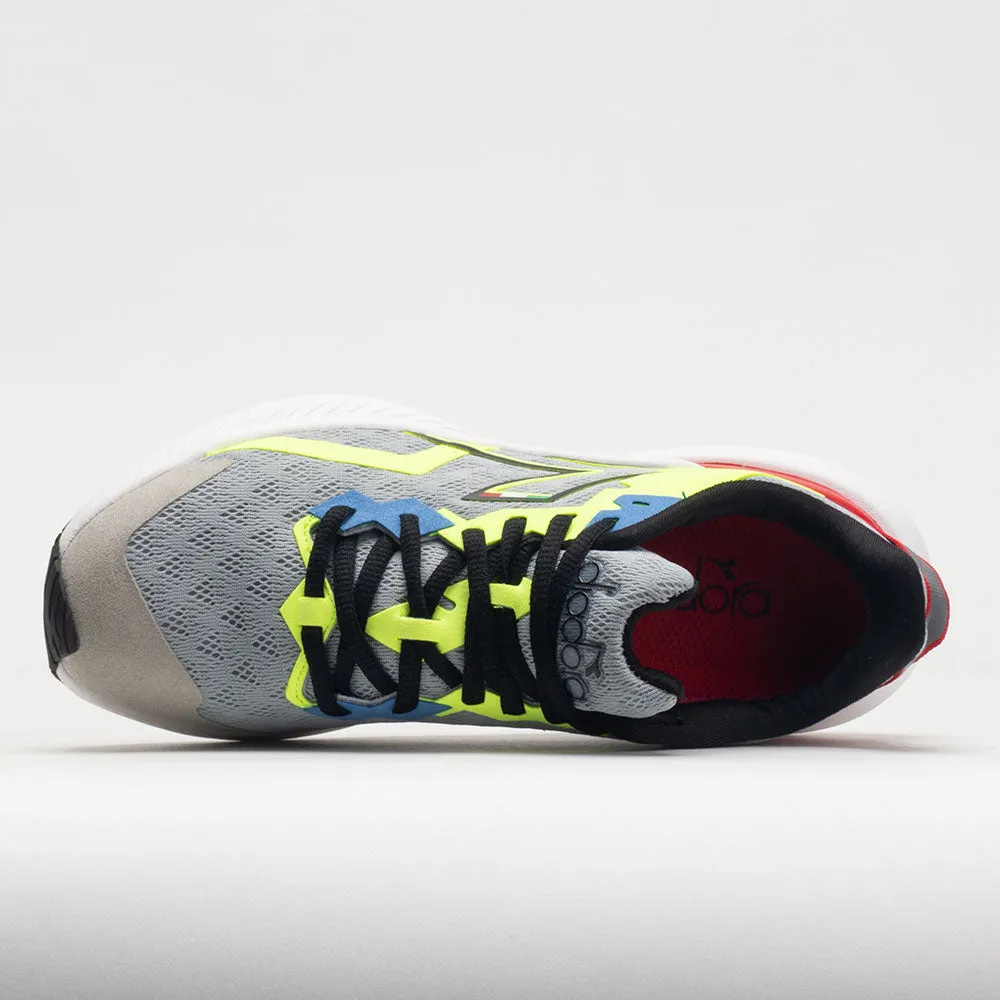 grassy terrain running in a tundra area Diadora Mythos Volo 3 Junior  Silver/Black/Yellow