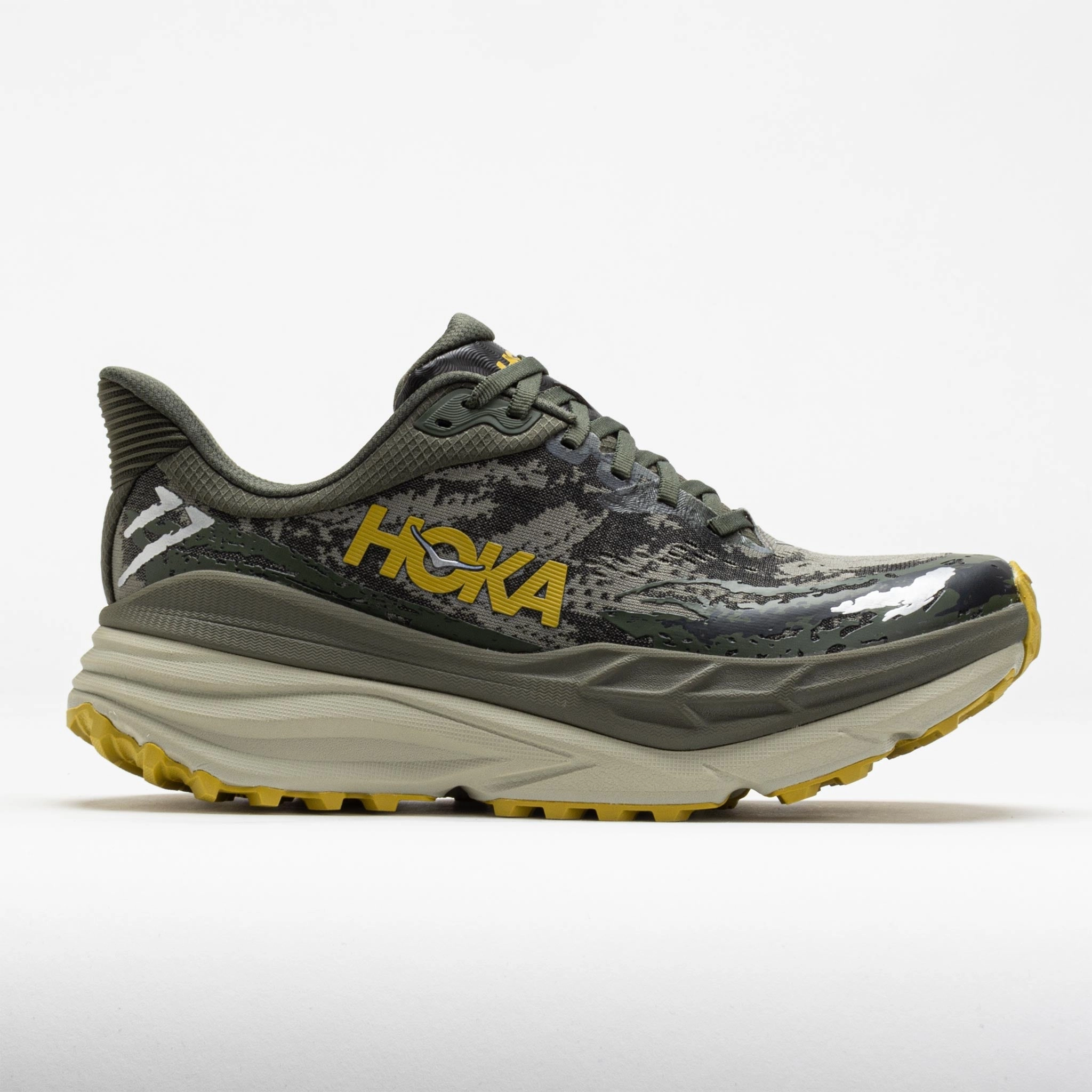 HOKA Stinson ATR 7 Men's  Olive Haze/Forest Cover park - running shoes running in a tennis court area shoes